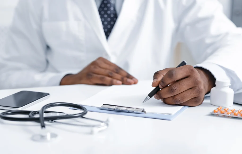 close up of african doctor prescribing pills to pa 2026 03 24 03 18 36 utc
